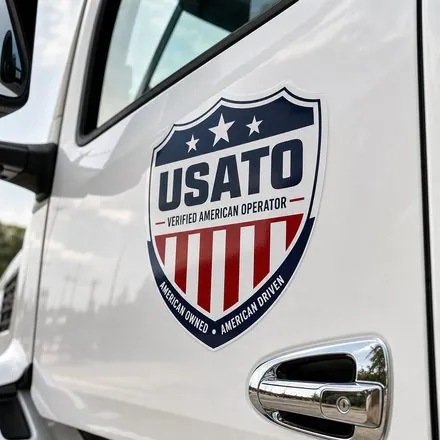 USATO Verified American Operator badge on an River Valley Auto Transport truck
